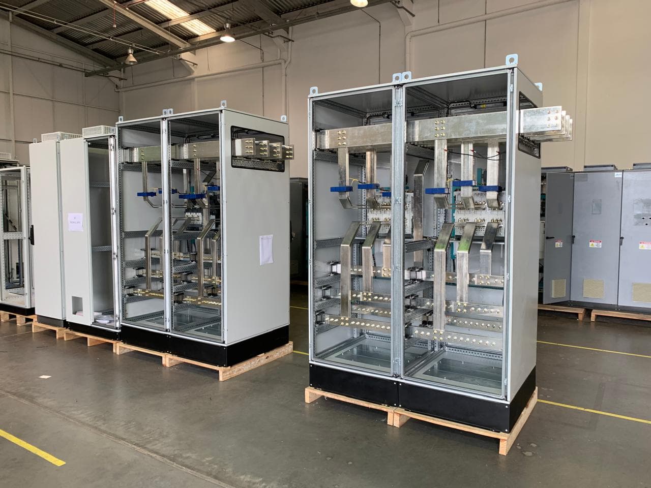 Columnas de panel sin puerta con barras plateadas y sensores azules, sobre palés