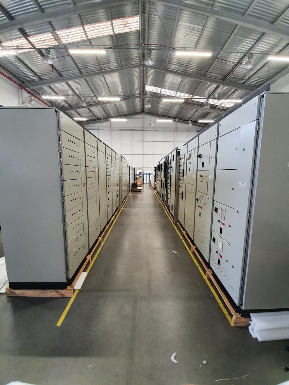 Pasillo entre filas de paneles modulares con cajones en nave